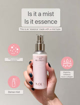 "Hand holding NOLA Collagen Skin Boosting Mist bottle with product features and benefits displayed"